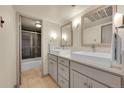 Updated bathroom with double sinks and gray vanity at 1365 Columbine St # 501, Denver, CO 80206