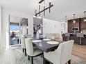 Bright dining room features a large table and modern chandelier at 3051 Newfound Lake Rd, Berthoud, CO 80513