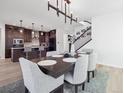 Open concept dining room with kitchen and staircase views at 3051 Newfound Lake Rd, Berthoud, CO 80513