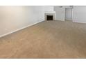 Spacious living room featuring a cozy fireplace and neutral carpeting at 10243 E Peakview Ave # A103, Englewood, CO 80111