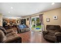 Spacious living room with kitchen views and backyard access at 3164 S Nucla St, Aurora, CO 80013