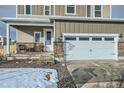 Two-story house with attached garage and a covered front porch at 17847 E 95Th Ave, Commerce City, CO 80022