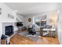 Bright living room with hardwood floors, fireplace, and bay window at 1307 Baker St # B, Longmont, CO 80501