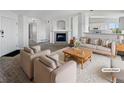 Virtually staged living room with fireplace and neutral decor at 6850 Xavier Cir # 12, Westminster, CO 80030