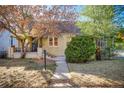 Charming bungalow home with a landscaped yard and front porch at 2103 S Lafayette St, Denver, CO 80210