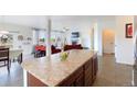 Open concept kitchen with an island, granite countertops and view of living room at 941 Saint Andrews Ln, Louisville, CO 80027