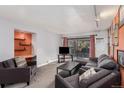 Living room with grey sectional sofa and balcony access at 1021 Carr St # 22, Lakewood, CO 80214