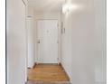Bright condo entryway with hardwood floors and white walls at 3460 S Poplar St # 307, Denver, CO 80224