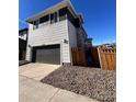 Two-story home with attached garage and a partially visible wooden fence at 21132 E 63Rd Dr, Aurora, CO 80019