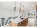 Open concept kitchen with island and stainless steel appliances at 2044 S Holly St # 5, Denver, CO 80222