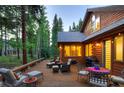 Back deck with seating area, surrounded by trees at 120 Windwood Cir, Breckenridge, CO 80424