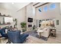 Spacious living room featuring a two-story fireplace and large windows at 8251 Estes Park Ave, Littleton, CO 80125