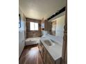 Clean bathroom featuring a bathtub, toilet, and vanity with updated countertops at 18064 E Ford Pl, Aurora, CO 80017
