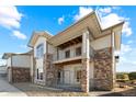 Two-story townhome building with stone accents and balconies at 18633 Stroh Rd # 2-103, Parker, CO 80134