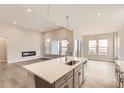 Open concept kitchen with island, modern cabinets, and hardwood floors at 1871 Grayside Cir, Castle Rock, CO 80109