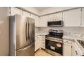 Modern kitchen with stainless steel appliances and granite countertops at 11753 Pennsylvania St, Northglenn, CO 80233