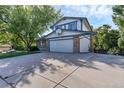 Two-story house with attached garage and landscaped yard at 11008 Vrain Ct, Westminster, CO 80031