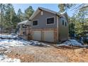 Two-story house with double garage and snowy landscaping at 746 Bow Mountain Rd, Boulder, CO 80304