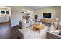 Virtually staged living room features modern furniture and dark hardwood floors at 762 S Simms St, Lakewood, CO 80228