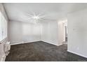 Spacious living room featuring neutral color tones and carpeted floors at 5995 E Iliff Ave # 307, Denver, CO 80222