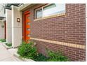 Sidewalk view of modern townhouses with orange doors at 2170 S Josephine St # 3, Denver, CO 80210