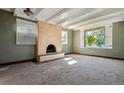 Bright living room with a fireplace and large window at 4684 S Lincoln St, Englewood, CO 80113