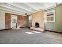 Spacious living room featuring a fireplace and brick wall at 4684 S Lincoln St, Englewood, CO 80113