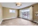 Bright living room with large window and hardwood floors at 1281 Worley Dr, Denver, CO 80221