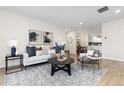 Bright living room with comfy seating, large windows, and stylish decor at 1133 Race St # 1B, Denver, CO 80206
