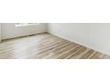 Spare bedroom with light wood flooring and a large window at 9374 Bahama Ct, Commerce City, CO 80022