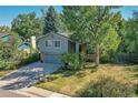 Two-story home with a gray exterior and a large, grassy yard at 6034 S Niagara Ct, Centennial, CO 80111