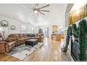 Open living room, hardwood floors, and a fireplace at 11868 High Desert Rd, Parker, CO 80134