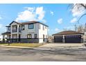 Modern two-story home with attached garage, stone accents, and landscaped yard at 2460 S Clay St, Denver, CO 80219