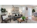 Cozy living room featuring a gray sofa, coffee table, and decorative accents at 17251 E Ford Dr, Aurora, CO 80017