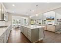 Modern kitchen with a large island, stainless steel appliances, and an open concept design at 7032 S Waterloo Way, Aurora, CO 80016