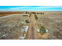 Aerial view of a log home on a large lot with a long driveway at 48155 E 56Th Ave, Bennett, CO 80102