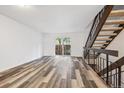 Bright living room with hardwood floors and sliding glass door to backyard at 7376 E Princeton Ave, Denver, CO 80237