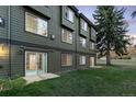 Rear exterior showing a sliding glass door and grassy area at 5077 Camel Heights Rd # C, Evergreen, CO 80439