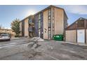 Exterior features a two-story building with parking and a dumpster at 865 S Quebec St # 104B, Denver, CO 80247