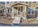 Front entrance of a townhome with stone and wood accents at 9535 E Alabama Cir, Denver, CO 80247