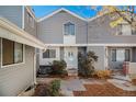 Gray siding townhouse exterior with a white door and landscaping at 91 S Nome St, Aurora, CO 80012