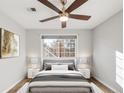 Spacious bedroom with a ceiling fan and large window at 4882 E Kentucky Ave # C, Denver, CO 80246