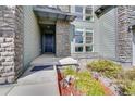 Front entrance with stone accents and landscaping at 8321 Estes Park Ave, Littleton, CO 80125