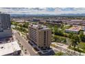 Modern apartment building near a river with mountain views in the background at 3575 Chestnut Pl # 606, Denver, CO 80216