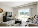 Living room with patio access and cozy furniture at 15700 E Jamison Dr # 8-103, Englewood, CO 80112