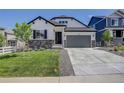 Modern farmhouse style home with gray garage door and landscaping at 5072 Ditmars Ln, Castle Rock, CO 80104