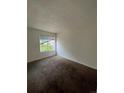 Bright bedroom with carpeted floors and a window at 10732 E Exposition Ave # 222, Aurora, CO 80012