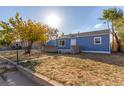 Newly remodeled blue house with a detached garage at 6971 Newport St, Commerce City, CO 80022