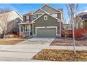 Inviting two-story home with front porch, attached garage, and well-maintained landscaping at 14934 Vienna Cir, Parker, CO 80134