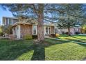 Side view of charming ranch home showcasing stone exterior and landscaping at 6650 E Arizona Ave # 205, Denver, CO 80224